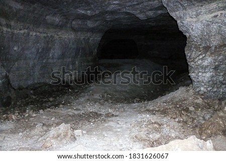 old abandoned galleries, adits, for extraction and processing of natural stone and gypsum cave. Dark eerie stone, quartz tunnels deep in earth. Various rocks, geological and speleological research.