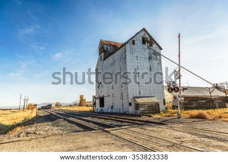 An old abandoned grainery at the edge of railroad tracks in Montana