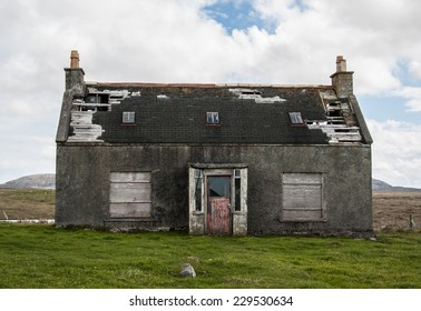 Old abandoned house in the countryside with broken roof and windows