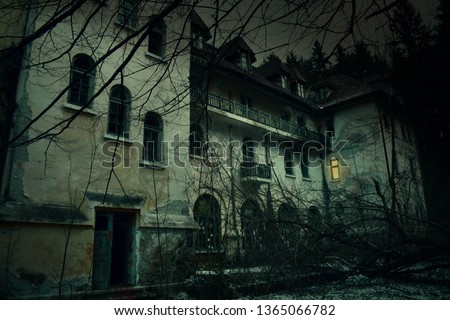 Old abandoned mansion in mystic spooky forest. The ancient haunted house of the crime scene with dark horror atmosphere and creepy details