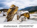 An old abandoned marble quarry. Marble quarry. Large white marble blocks in an old abandoned quarry. View from the marble quarry in autumn. Selective focus.