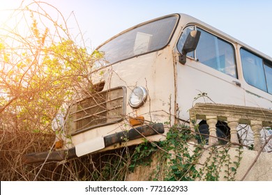 Old Abandoned Minivan In The Bushes