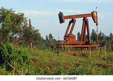 Old, Abandoned Oil Pump On A Now-dry Well In Oklahoma, Rusting Away A Little At A Time.