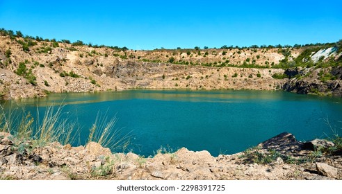 Old abandoned quarry lake filled with emerald water with radon                                - Powered by Shutterstock