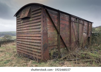 Old Abandoned Railway Carriage On The Moorland. Red Rustic Metal And Wooden Panels.