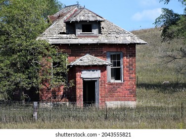 Old Abandoned, Red Brick School House Slowly Decaying In The Midwest