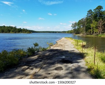 Old abandoned road that is falling into lake.
