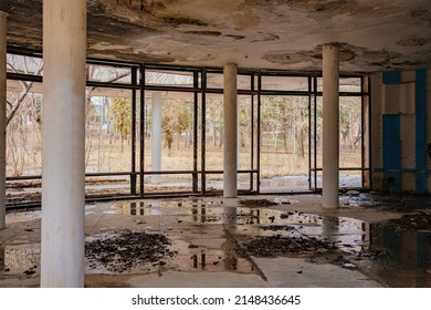 An Old Abandoned And Ruined Building With A Wet Ceiling And Puddles On The Floor. Destruction, Poverty And War. Rehabilitation And Reconstruction Of Premises.