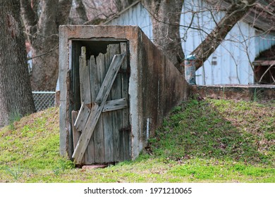 old abandoned rundown worn broken down storm shelter access door weathered over time as a rural landscape scene