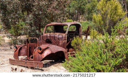 An old abandoned rusting vehicle lying in scrub land near Maldon Australia