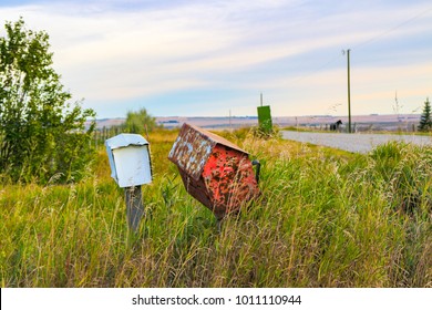 Old Abandoned Rusty Mail Boxes, Slowly, Leaning And Falling, Fading Into The Past, An Era Of Rural Mail Delivery Service Passes Away 