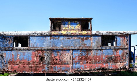 old abandoned rusty metal painted railroad train caboose - Powered by Shutterstock