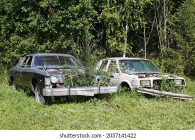 Old abandoned rusty vehicles, crushed cars in junkyard. Cars recycling concept. - Shutterstock ID 2037141422