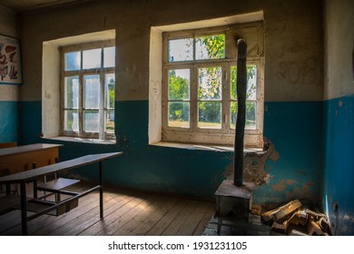 Old And Abandoned School Classroom Interior. Dirty Grunge Room With Windows And Desks. Selective Focus