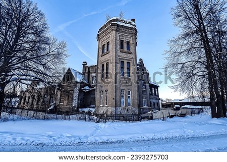 Old abandoned tower. View of ruins of manor in sunny winter day.