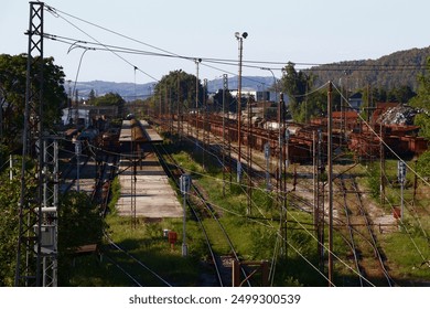 The old, abandoned trains sat quietly on their rusted tracks, shrouded in an air of forgotten glory. Their once gleaming exteriors were now mottled with rust and peeling paint. - Powered by Shutterstock