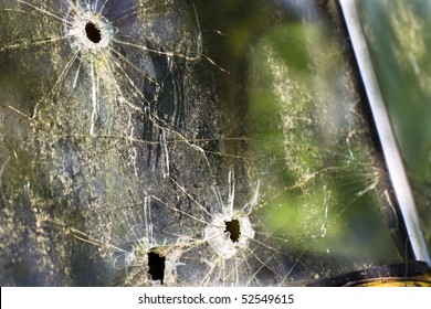 An Old Abandoned Truck In A Field With Bullet Holes In The Windshield