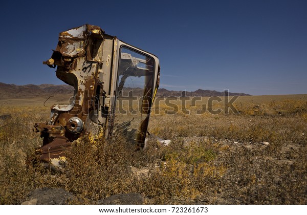 old and abandoned truck turned on the side in\
the steppe, Kazakhstan