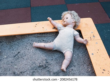 Old Abandoned Unloved Doll In The Playground