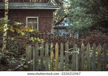 An old abandoned village. Dilapidated wooden house. Residents left their homes and left. Abandoned garden plots.