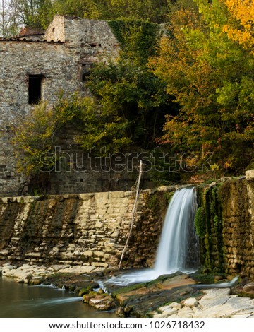 The old abandoned water mill in autumn