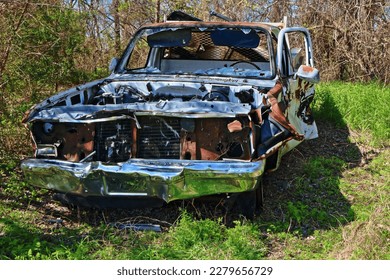 An old, abandoned and weathered pickup truck lies forgotten along a trail in a Texas Nature Preserve - Shutterstock ID 2279656729