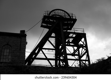Old abandoned Welsh Coal Mine Pit Gear Silhouette, stormy sky