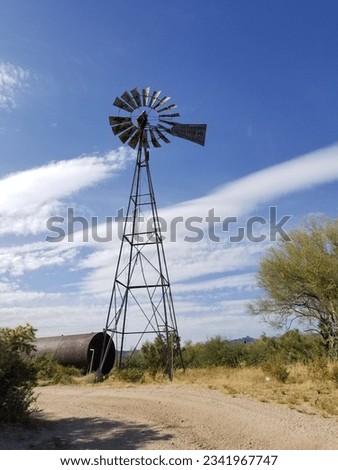 An old abandoned windmill and storage tank in the desert