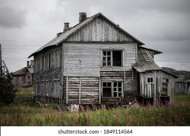Old abandoned wooden house over the cloudy sky