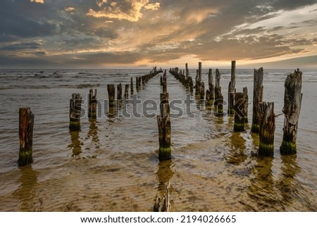 Old abandoned wooden pier or jetty remains on a Baltic sea