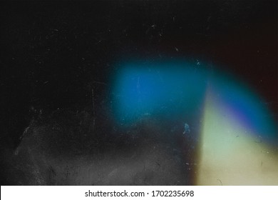 Old abstract background. Blue effect on black. Film grain texture. Vintage style. redacted. Lens flare and heavy grain. 70s

