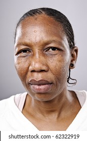 Old African Woman Looks At Camera With Sad Eyes