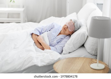 Old Age And People Concept - Senior Woman With Eye Mask Sleeping In Bed At Home Bedroom