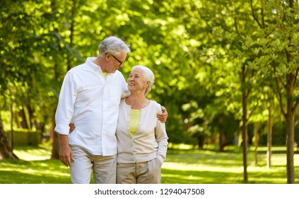 Old Age, Relationship And People Concept - Happy Senior Couple Hugging In City Park