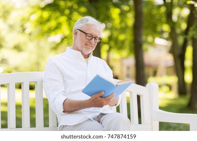 old age, retirement and people concept - happy senior man reading book sitting on bench at summer park - Powered by Shutterstock