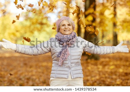 old age, retirement and season concept - happy senior woman enjoying beautiful autumn outdoors