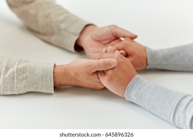 Old Age, Support, Charity, Care And People Concept - Close Up Of Senior Man And Young Woman Holding Hands