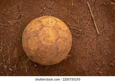 Old, Aged and Damaged Leather Soccer Ball, Football on Dirt Playground in the Rural Area. - Shutterstock ID 2205735193