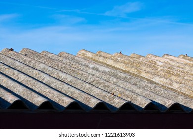 Old aged dangerous asbestos roof made of concrete panels - one of the most dangerous materials in buildings so-called ‘hidden killer’ 