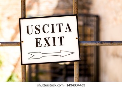 Old and aged exit sign. Exit sign in english and italian language.