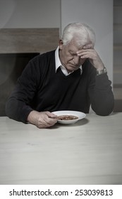 Old Aged And Lonely Man Eating Soup