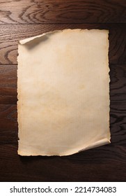Old aged paper or scroll on wooden table.