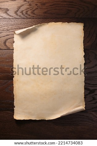 Old aged paper or scroll on wooden table.
