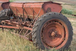 Old Agricultural Machineries. Rusty Seeder On The Edge Of A Field.