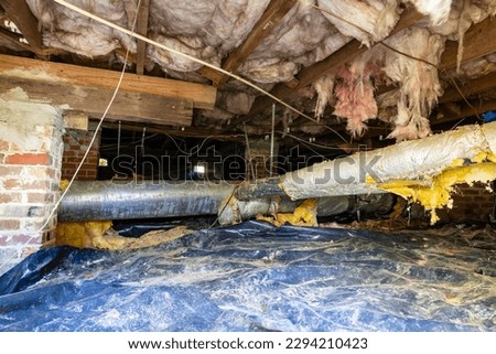 Old air conditioner duct work under house needing maintenance