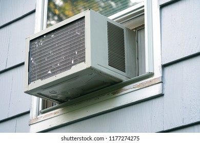 Old Air Conditioner Installed On House Window