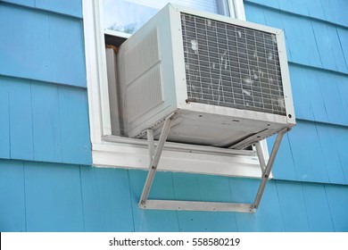 old air conditioner installed on house window