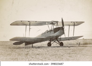 Old airplane at the airfield. Air travel with biplane - concept of retro aviation. Retro image of old aircraft. Vintage airplane closeup.