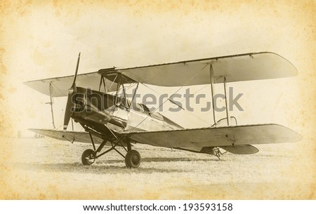 Old airplane at the airfield. Air travel with biplane - concept of retro aviation. Retro image of old aircraft. Vintage airplane closeup.