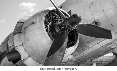 old airplane engine with a propeller and the nacelle on the background of the fuselage